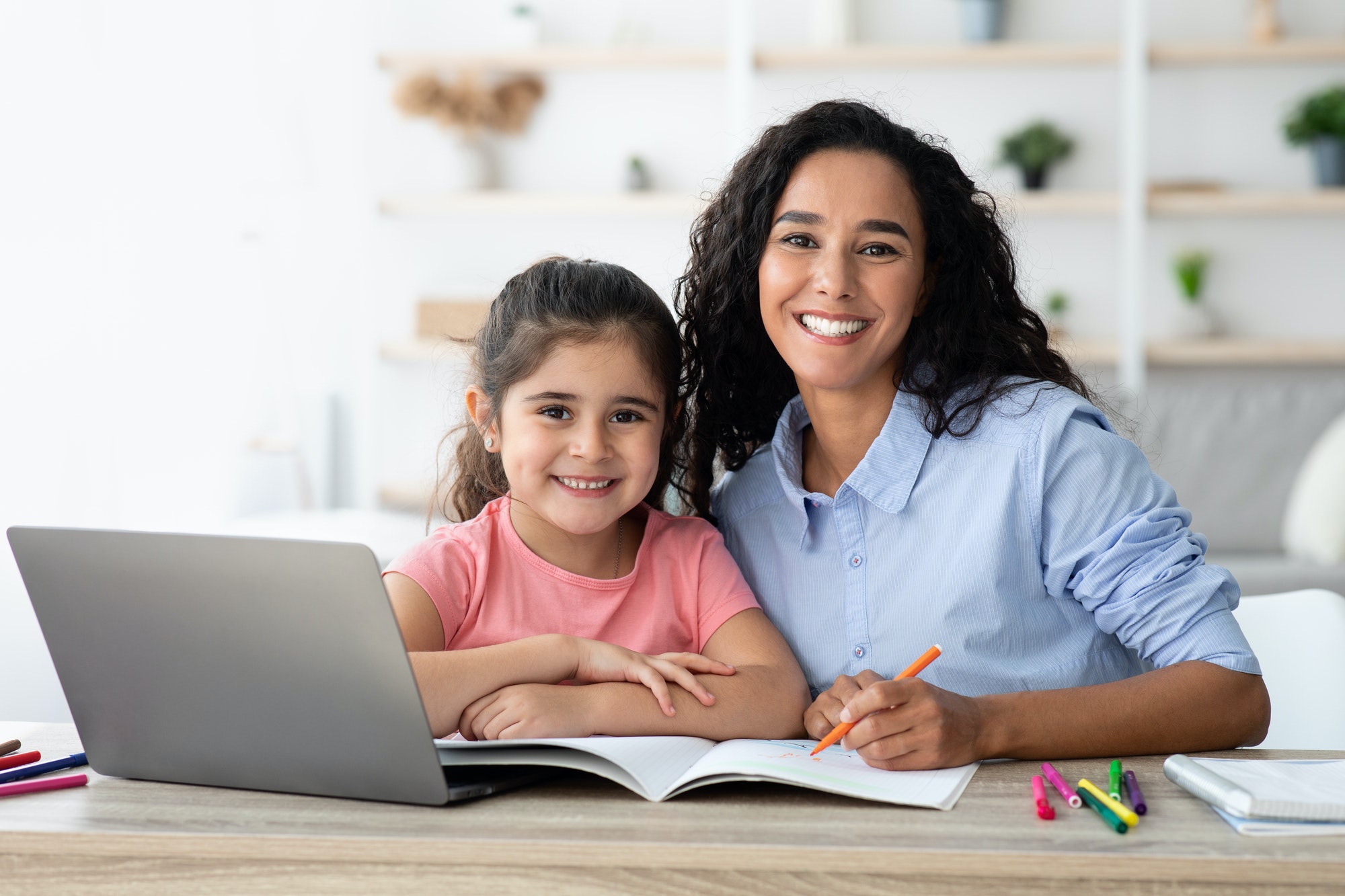 Young Mother Making Homework With Little Daughter, Helping With Study At Home